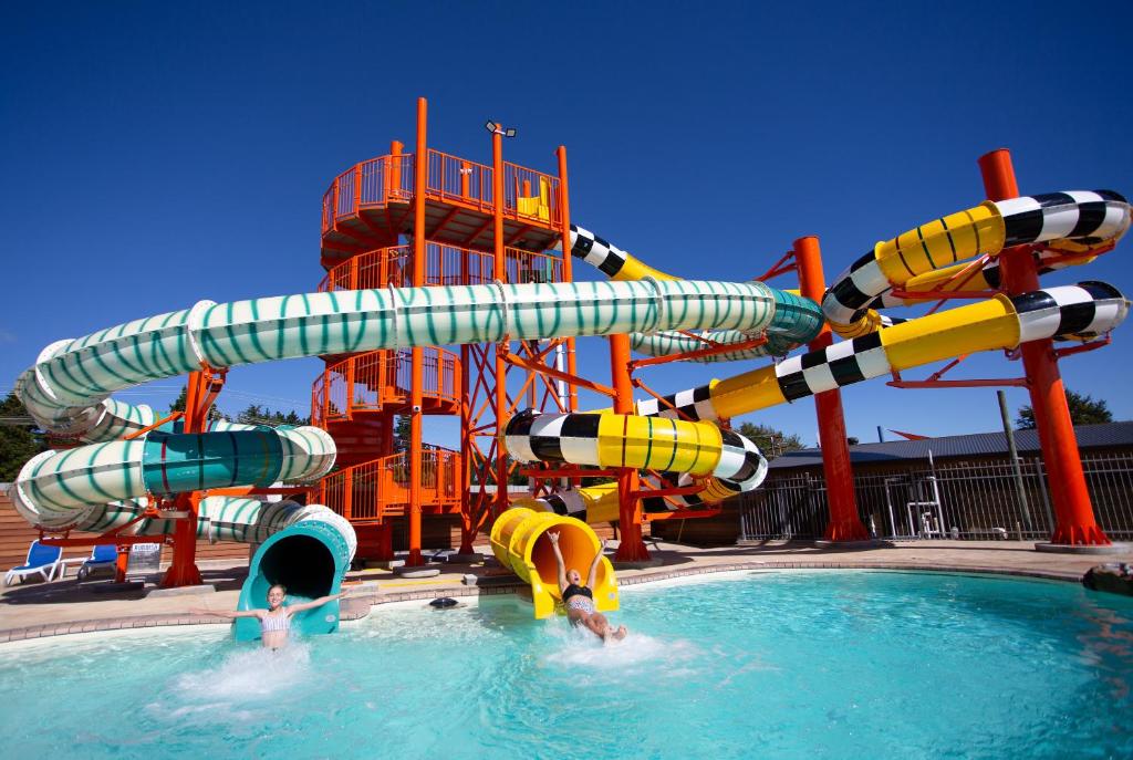 Un tobogán de agua en una piscina con gente en el agua en Lake Taupo Holiday Resort, en Taupo