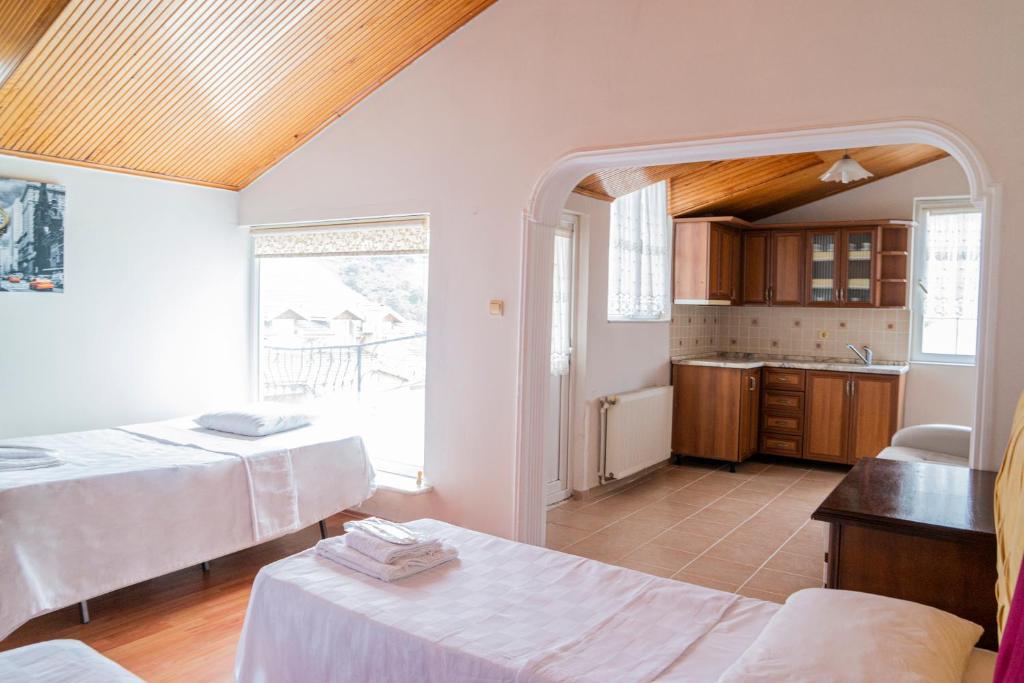 a large room with two beds and a kitchen at DES VILLA Trabzon in Trabzon