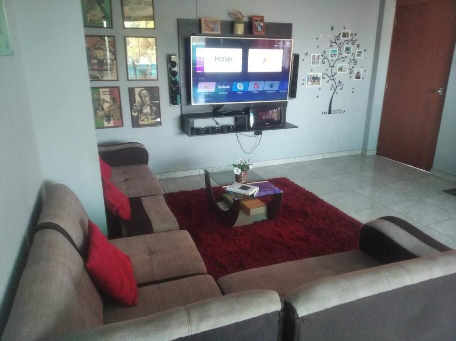 a living room with a couch and a flat screen tv at Jack Appart (departamento 2 cuartos y terraza) in Arequipa