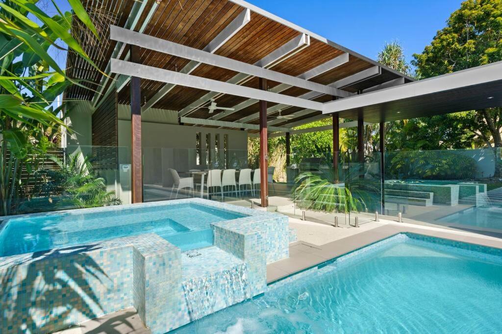 a swimming pool in a house with a patio at Witta Circle - Walk to Hastings St & Noosa Beach in Noosa Heads