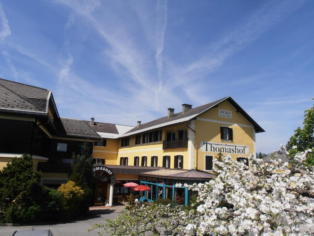 a hotel with flowers in front of a building at Der Thomashof in Sankt Jakob im Rosental