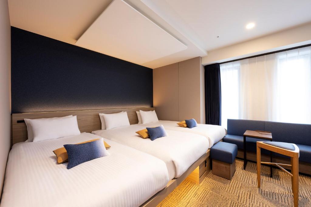 Postel nebo postele na pokoji v ubytování HOTEL AMANEK Shinjuku Kabukicho