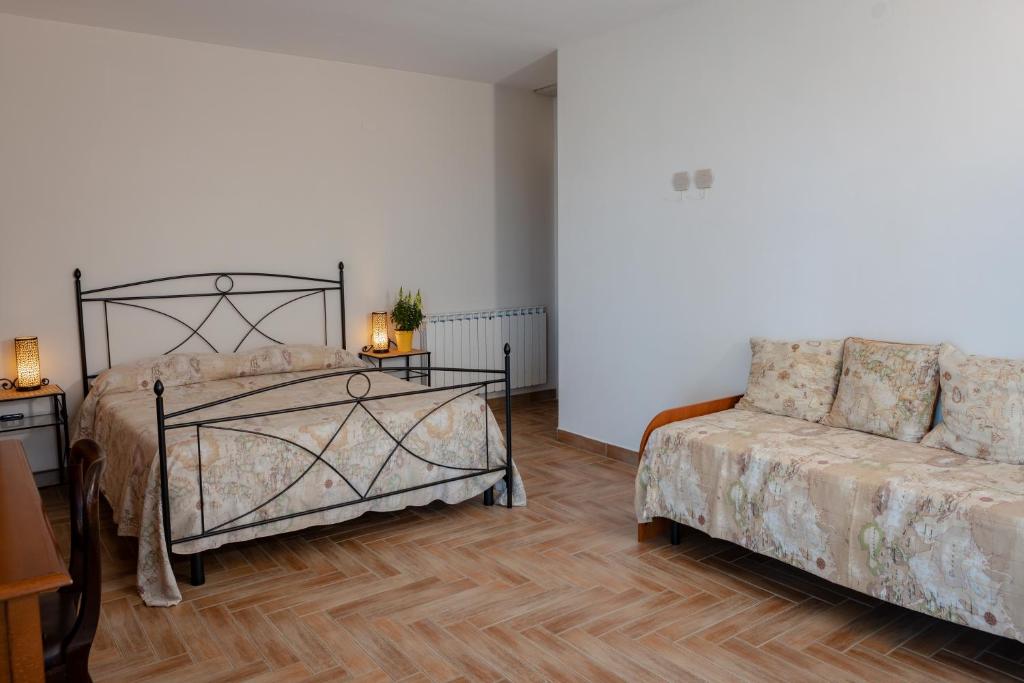 a bedroom with a bed and a couch at Villa Marianna in Vasto