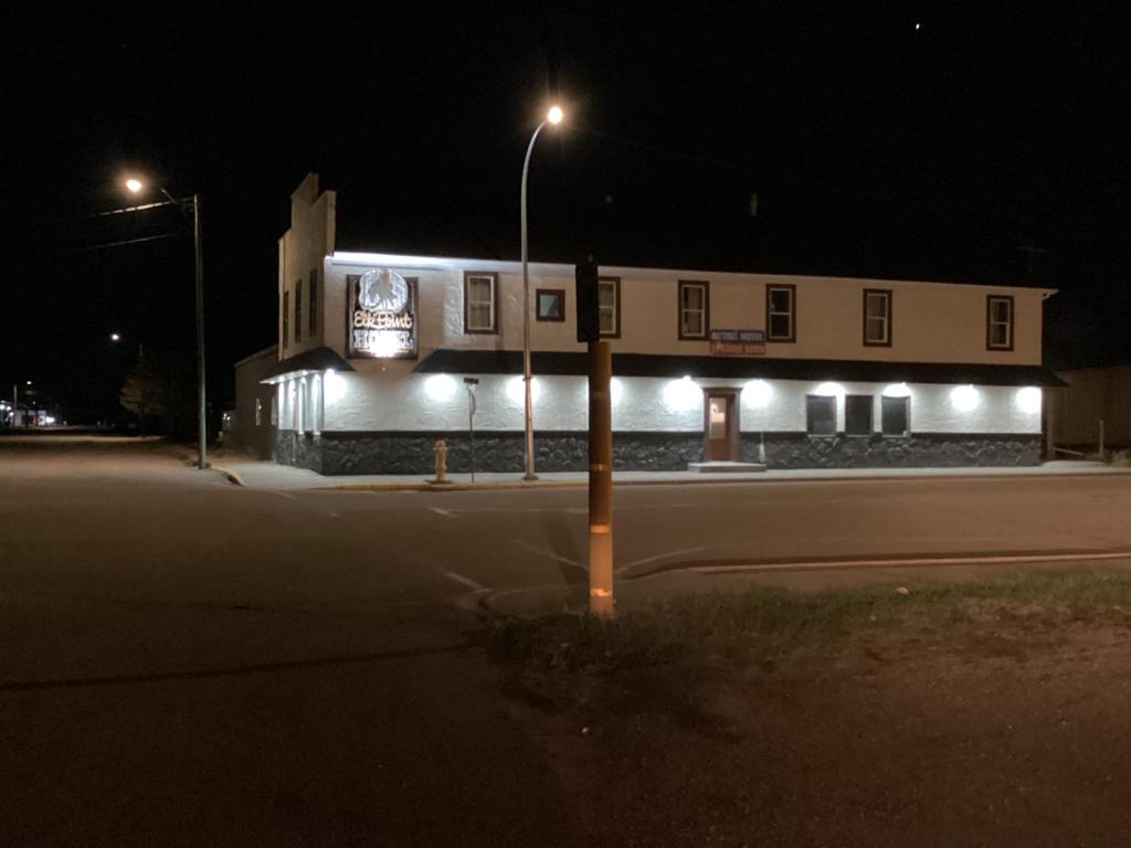 a building with lights on the side of it at night at Bethel hotel Elk Point in Elk Point