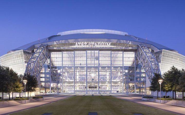 a large building with a lot of windows at Walk to the Cowboys Game! Luxury Apt sleeps 4! in Arlington