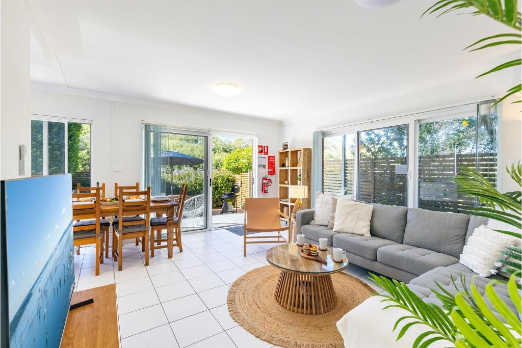 a living room with a couch and a table at Fingal Bay Coastal Retreat 1 12 Marine Dr fantastic ground floor duplex in Fingal Bay