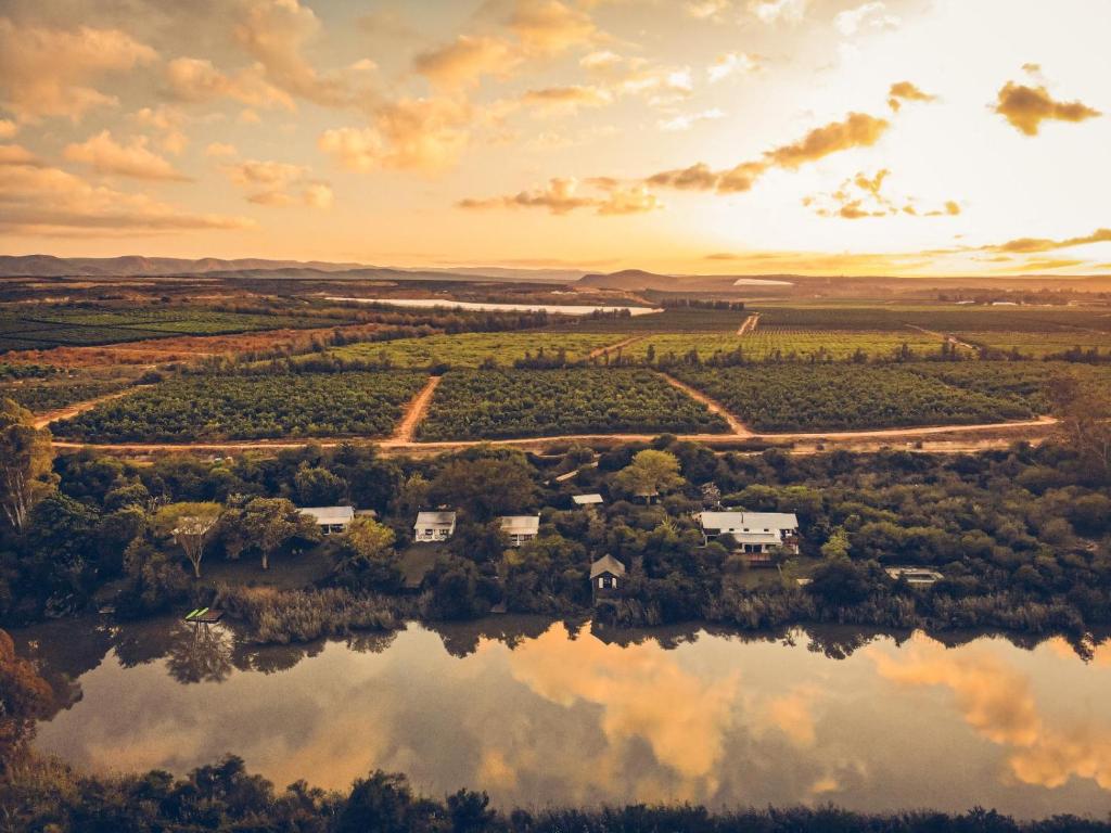 an aerial view of a farm on a lake at Ndlovu Addo River Lodge in Kirkwood