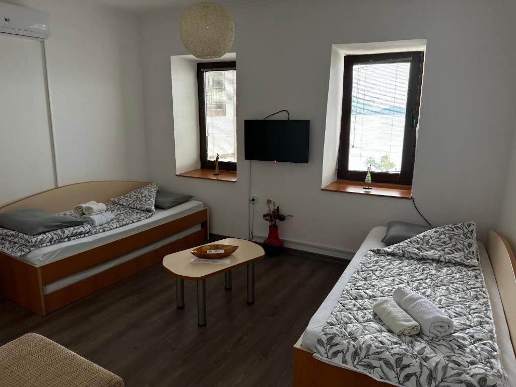 a small room with two beds and a table at Savin Apartment in Ohrid