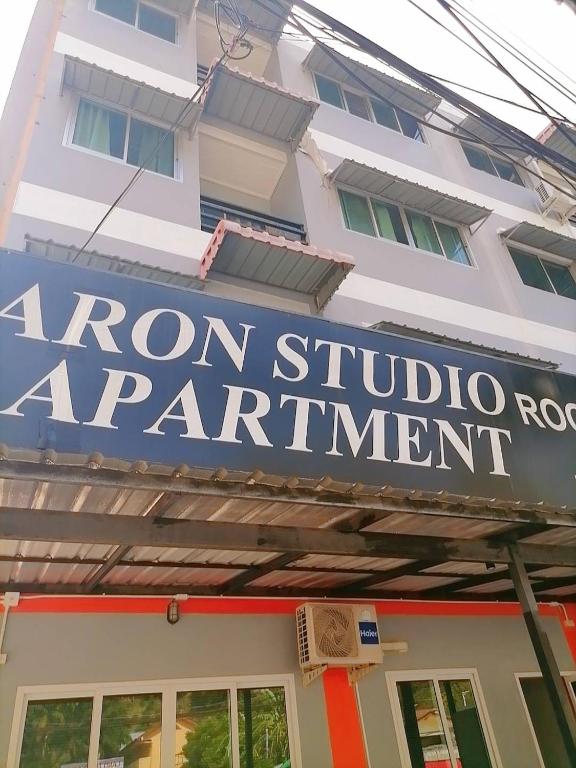 a sign for a roman studio apartment in front of a building at KARON STUDIO APARTMENT in Karon Beach