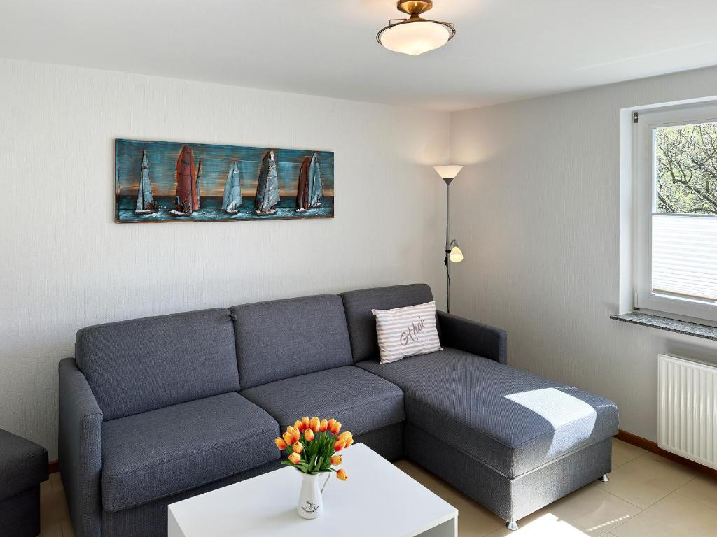 a living room with a couch and a table at Haus *Üüs Aran* Wohnung Nr. 4 in Nebel