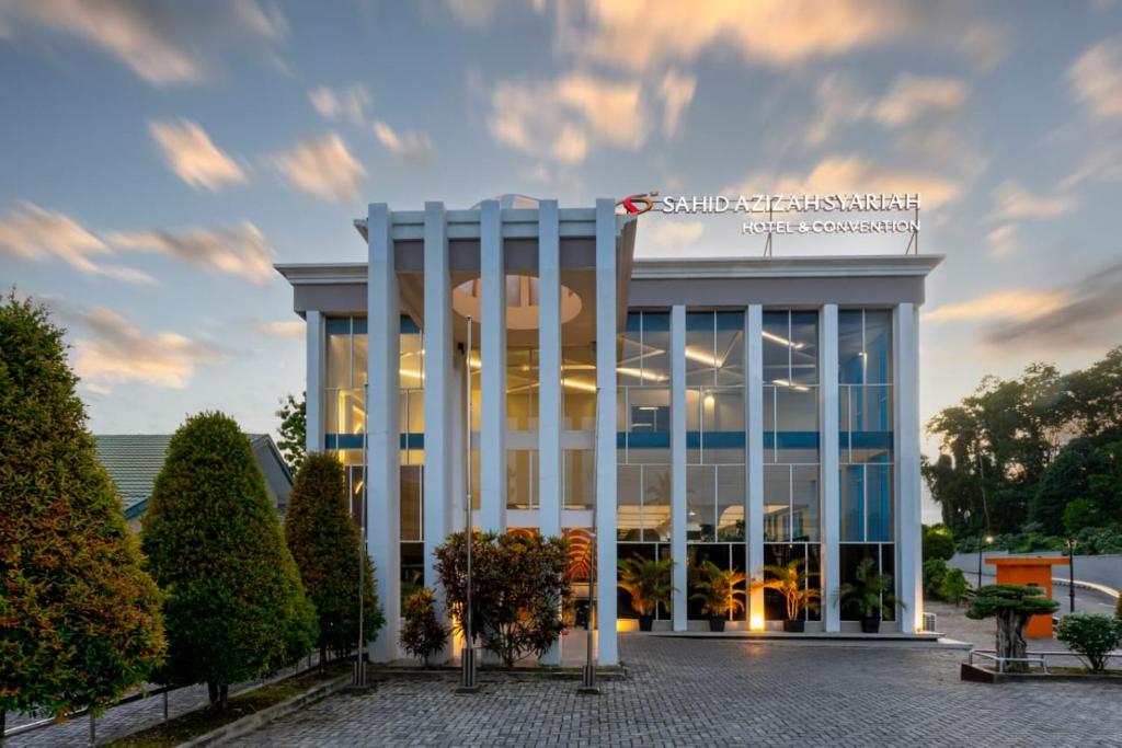 a building with white columns in front of it at Sahid Azizah Syariah Hotel and Convention Kendari in Lepoleop