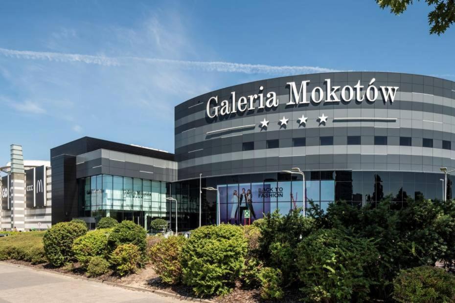 a building with a sign on the front of it at Airport Apartment in Warsaw