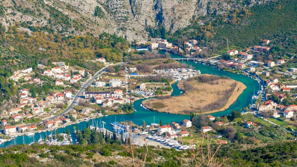 an aerial view of a small town next to a river at Apartment Relax in Mokošica