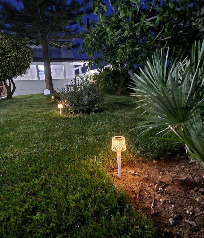 a garden with two signs in the grass at Meraviglia d'Otranto in Otranto