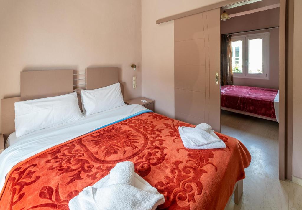a bedroom with a large bed with towels on it at Fantastic Matala 1 in Matala