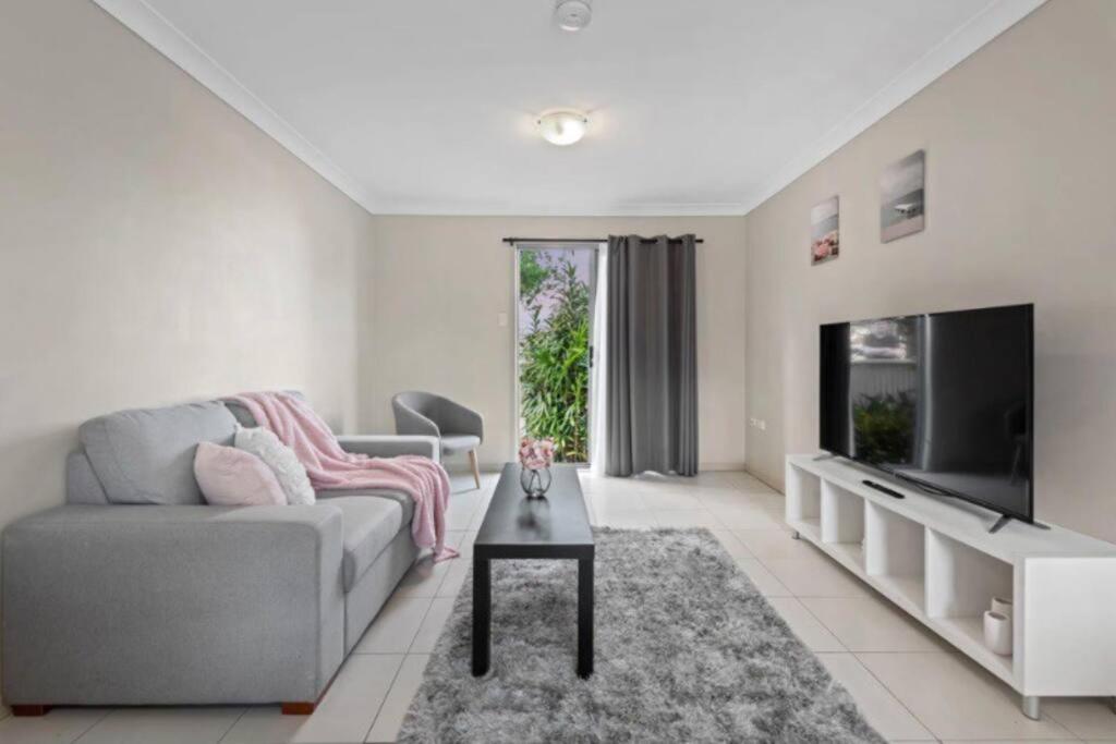 a living room with a couch and a tv and a table at One bedroom holiday rental in Scarborough in Scarborough