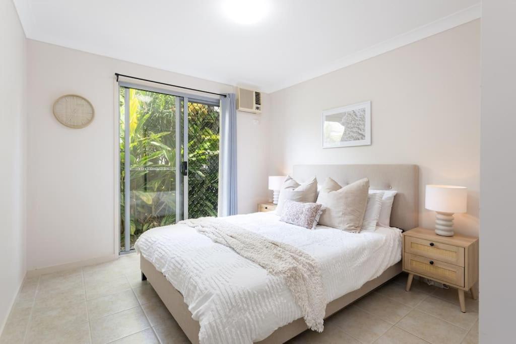a white bedroom with a bed and a window at Self-contained unit in Scarborough in Scarborough