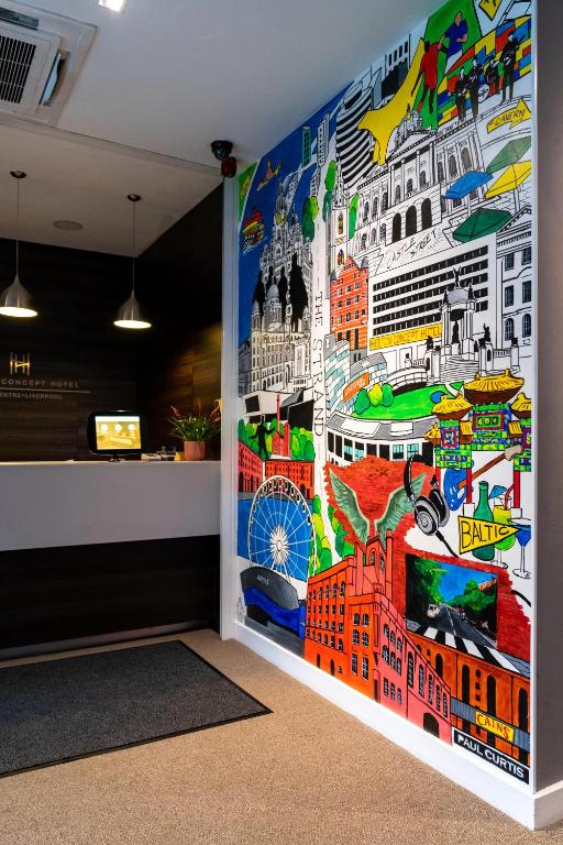 a wall in a room with a mural of cities at Heeton Concept Hotel - City Centre Liverpool in Liverpool