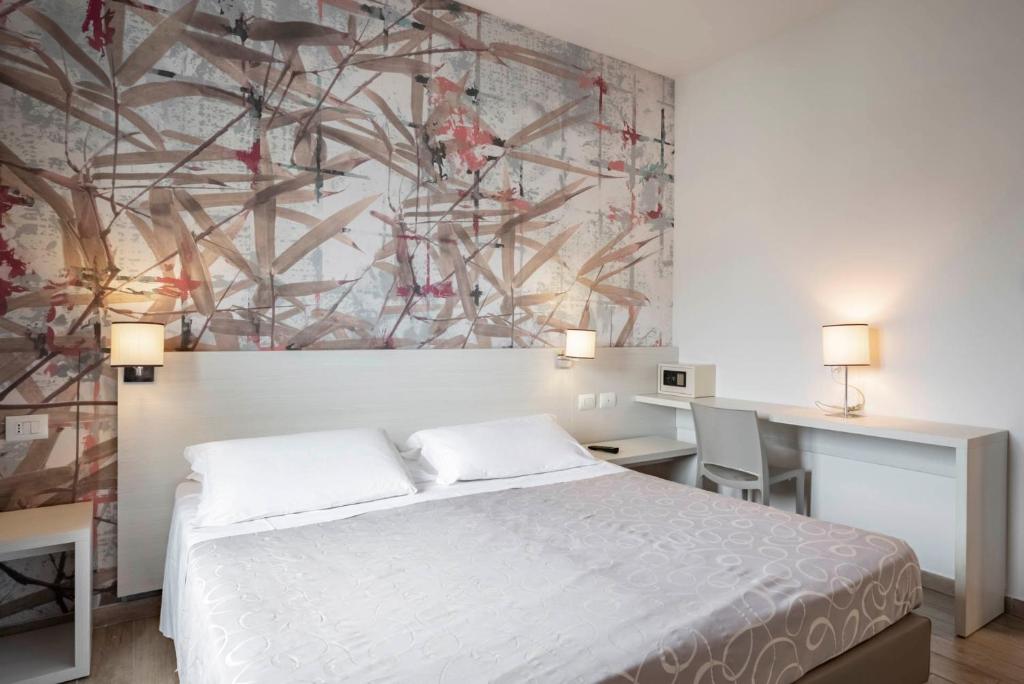 Postel nebo postele na pokoji v ubytování Hotel La Pineta