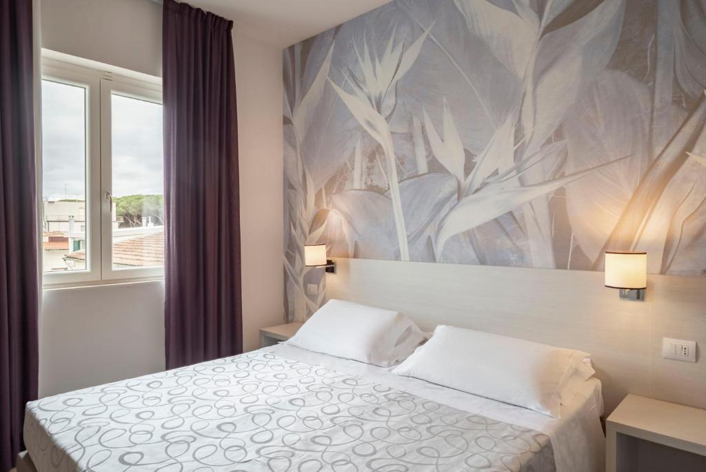 Postel nebo postele na pokoji v ubytování Hotel La Pineta