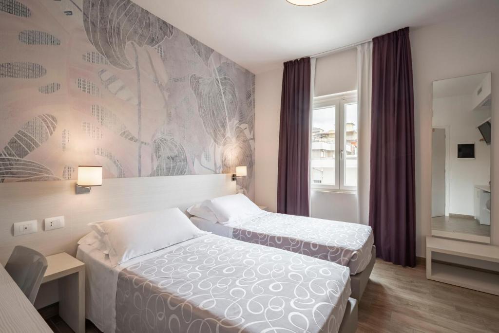 Postel nebo postele na pokoji v ubytování Hotel La Pineta