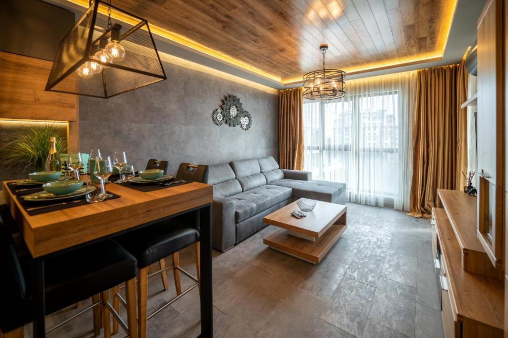 a living room with a couch and a table at Apartment Deluxe Vision in Varna City