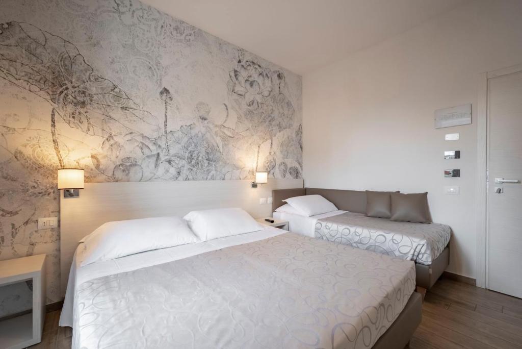 Postel nebo postele na pokoji v ubytování Hotel La Pineta