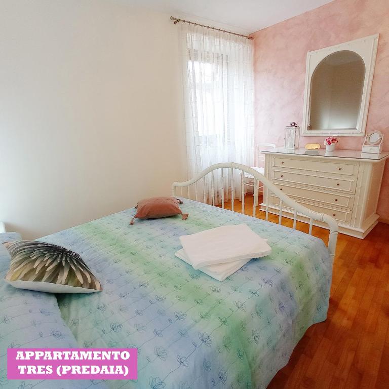 a bedroom with a bed with a dresser and a mirror at APPARTAMENTO TOMA MIHAELA in Tres