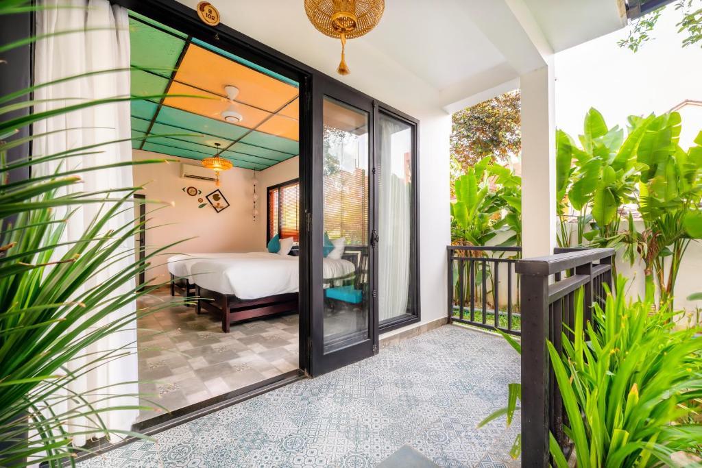 Postel nebo postele na pokoji v ubytování Sunkised Paddy Hoi An Villa