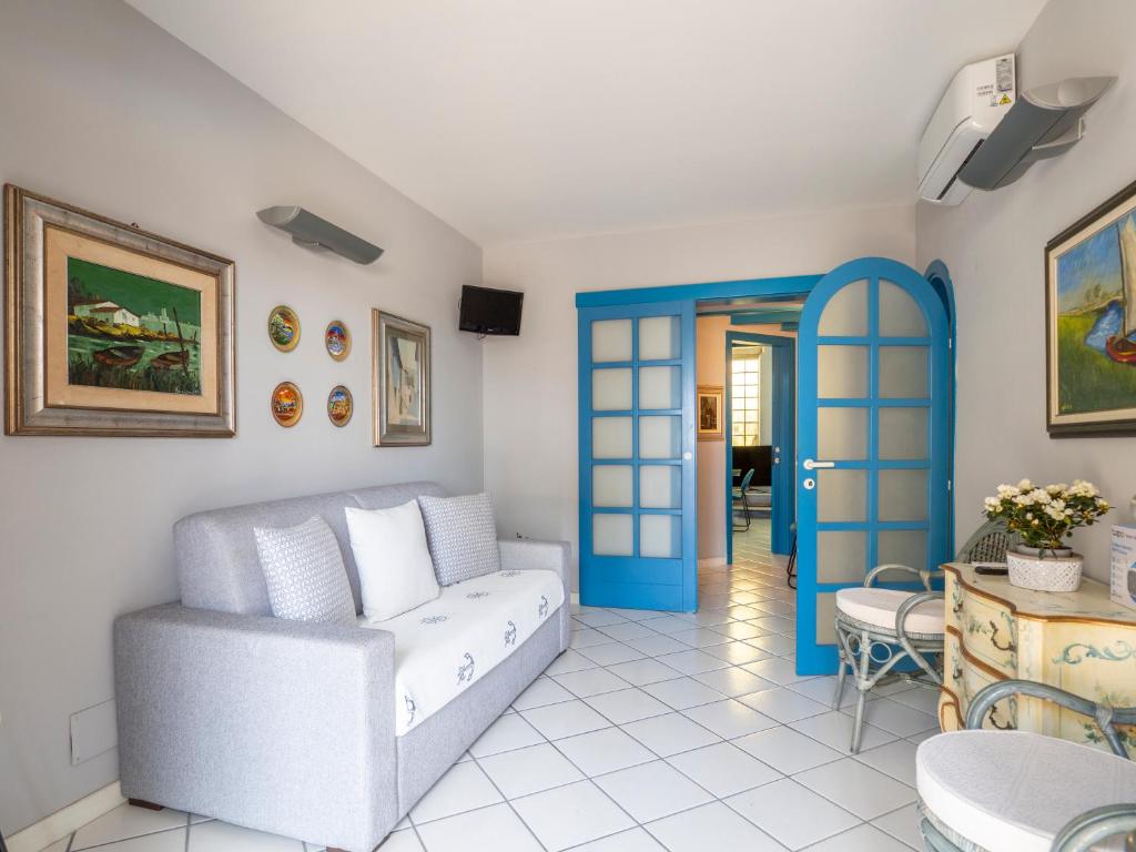 a living room with a couch and a table at Casa nel Blu in Portoscuso