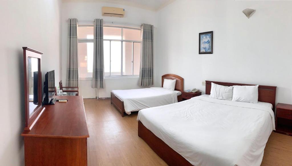 Voodi või voodid majutusasutuse My Khe 2 Da Nang Seafront Hotel toas