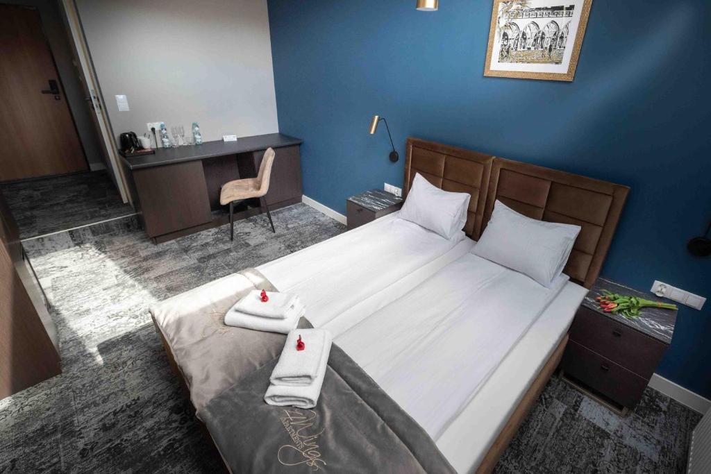 Postel nebo postele na pokoji v ubytování 4Wings Apartments