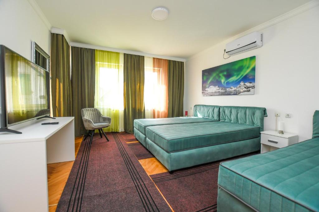 a hotel room with a couch and a television at Apartment Vujovic in Kladovo