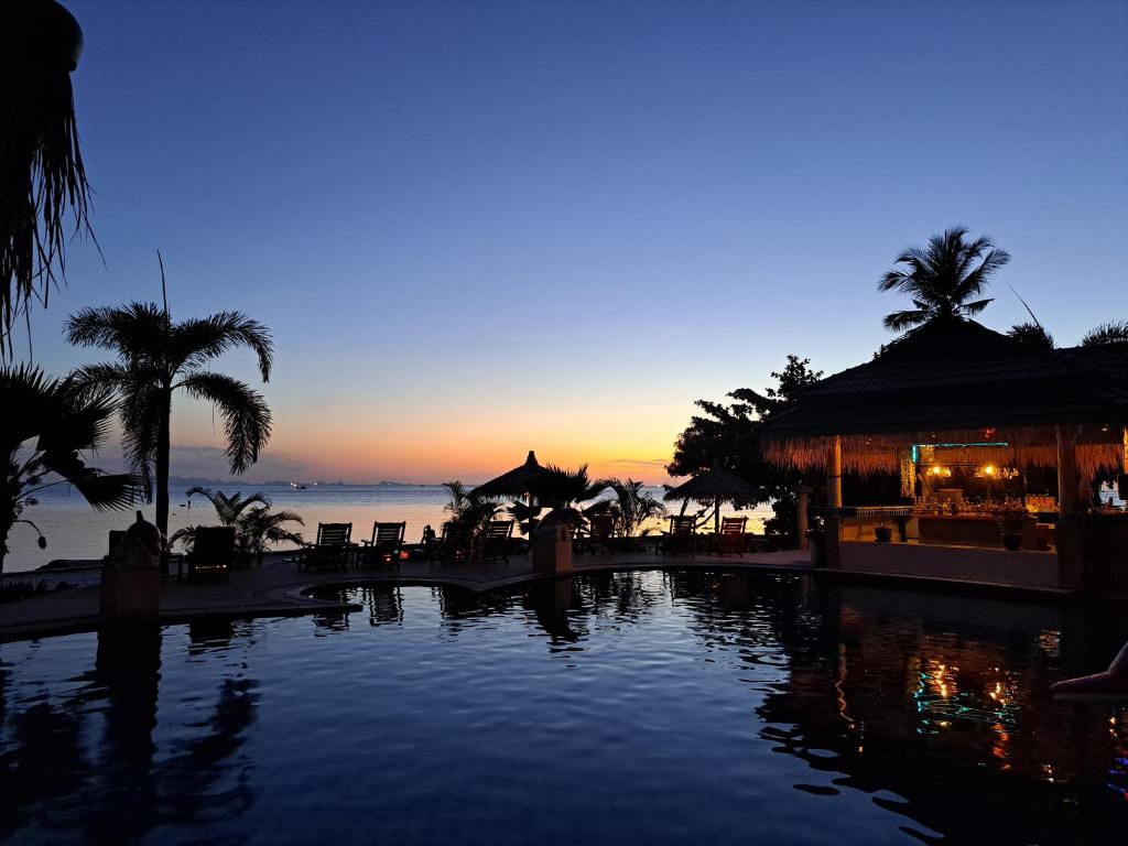a view of a pool at a resort at dusk at Sense Asia in Haad Tian