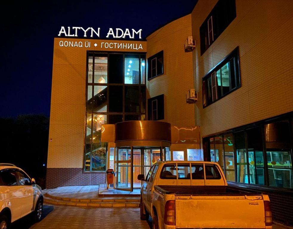 a truck parked in front of a building at night at Altyn Adam Hotel in Petropavlovsk
