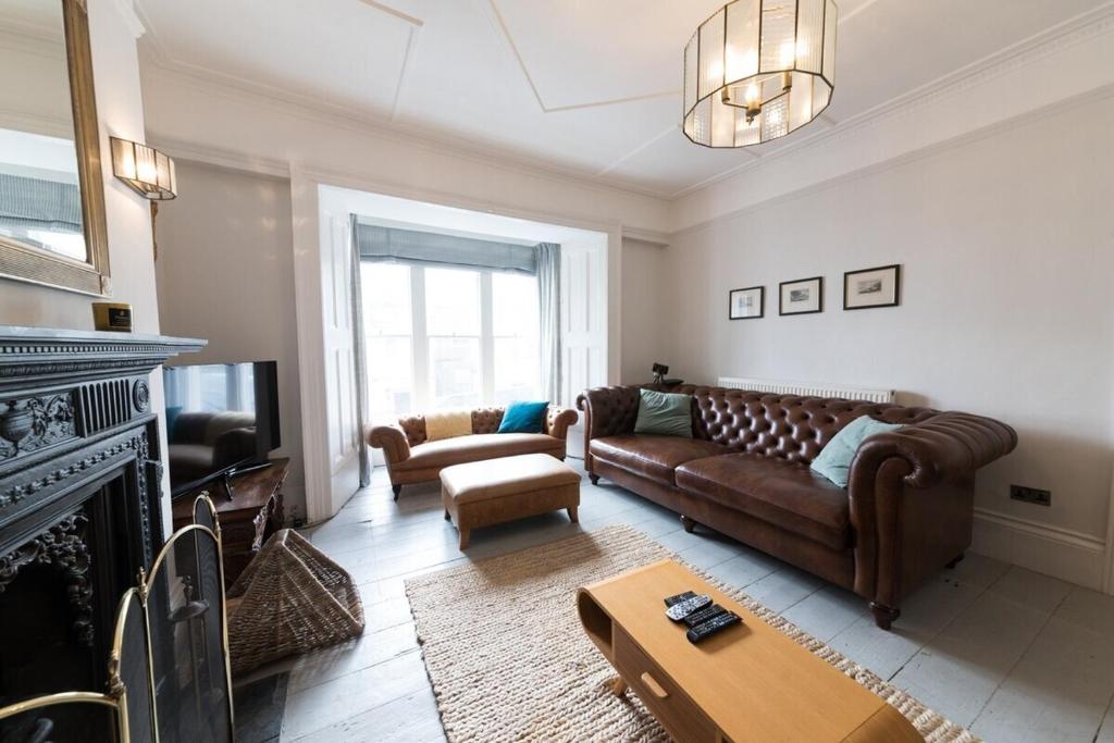 a living room with a couch and a fireplace at Sea Front St Leonards in Hastings