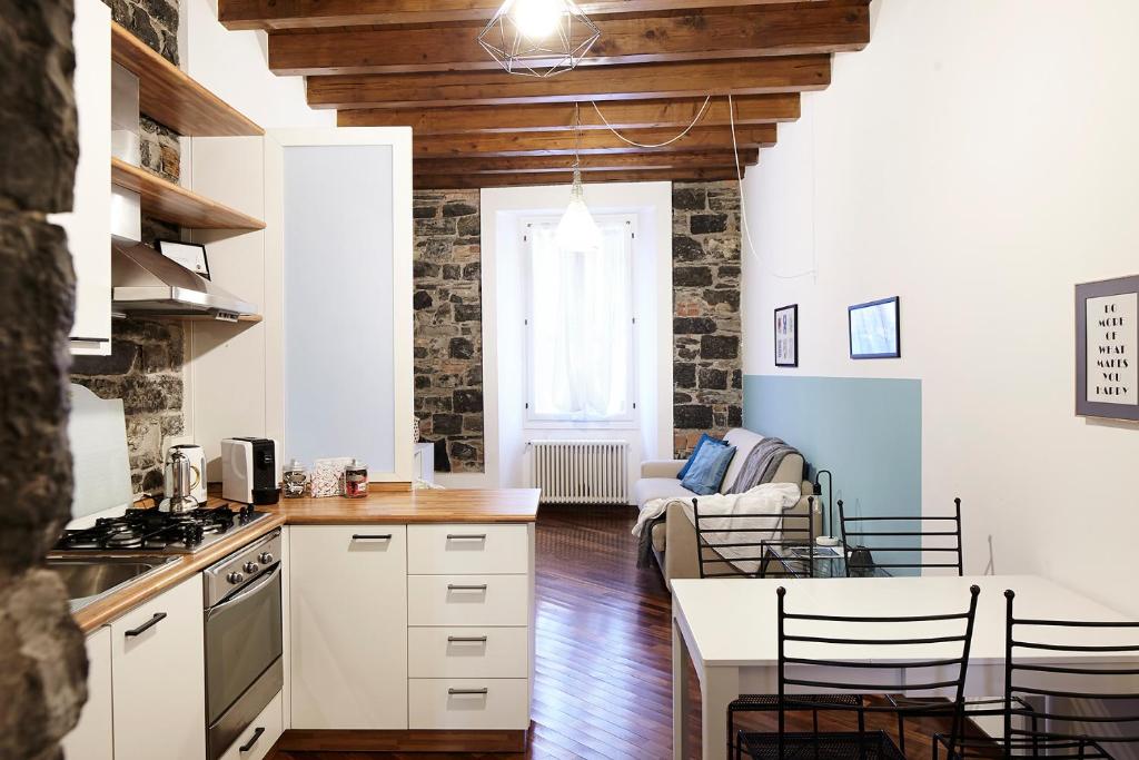 a kitchen and living room with a table and chairs at Il Moderno by Holiday Solutions in Como