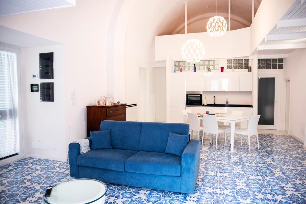 a living room with a blue couch and a table at River Song - Vietri sul Mare in Vietri