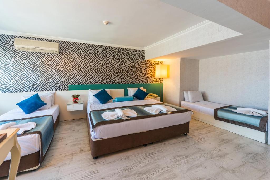 Postel nebo postele na pokoji v ubytování Viva Deluxe Hotel