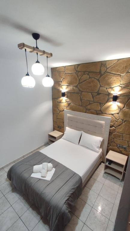 A bed or beds in a room at Alexander Apartments Nea Koutali