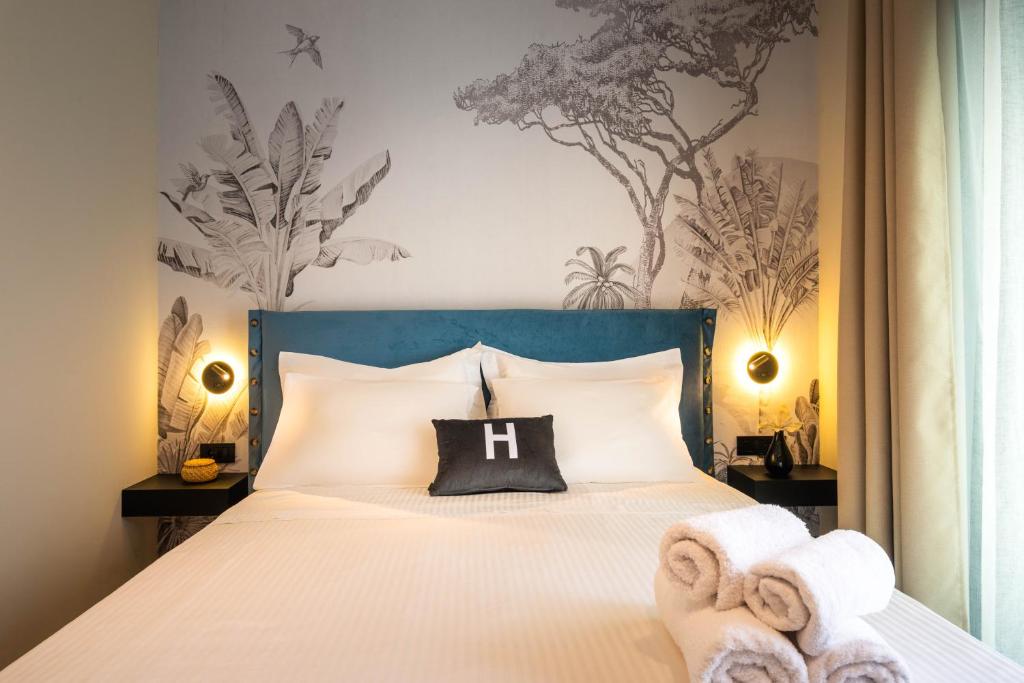 Postel nebo postele na pokoji v ubytování Hara Suites