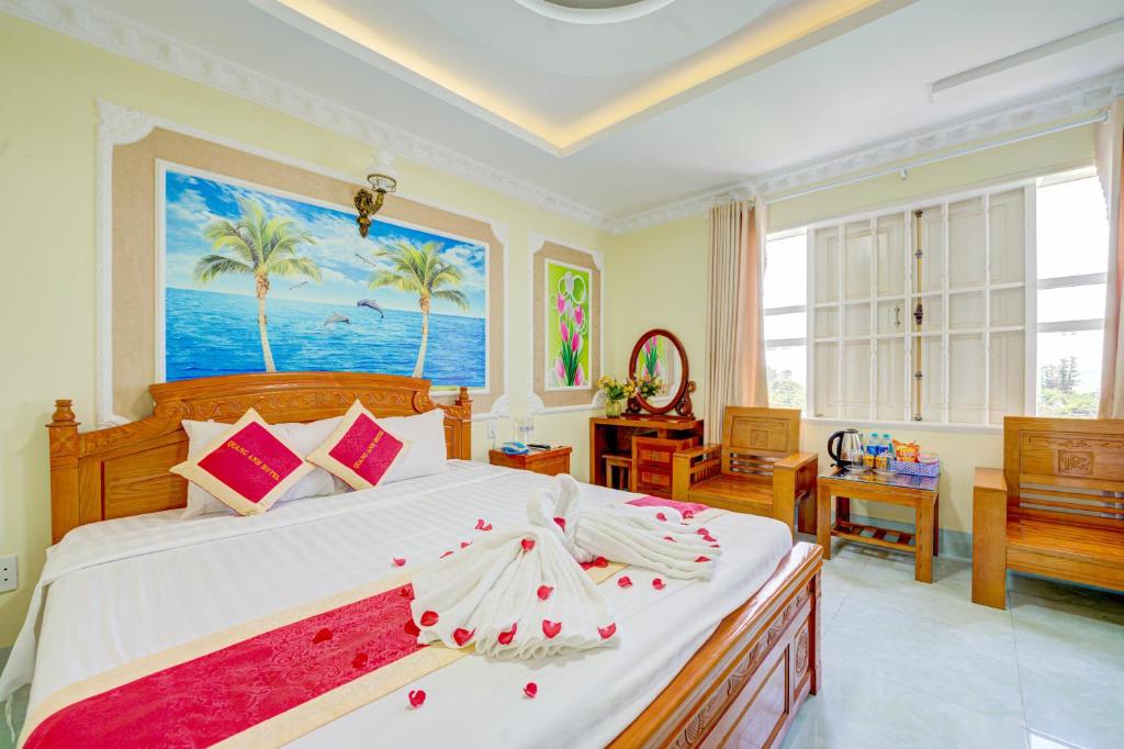 a bedroom with a large bed and a large window at The Moment - Quang Anh Hotel Vũng tàu in Vung Tau