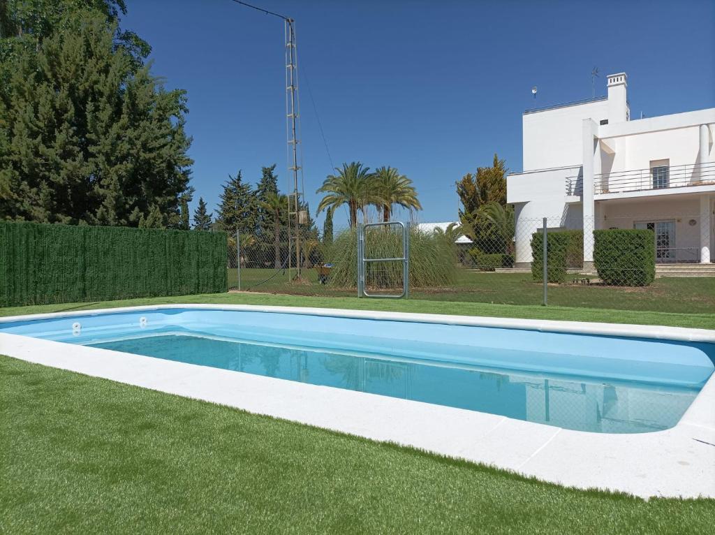 a swimming pool in the yard of a house at Finca Campo Viejo in Isla Cristina