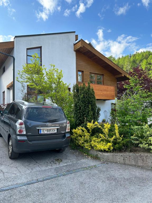 a car parked in front of a house at Bijou Guest House in Mieders