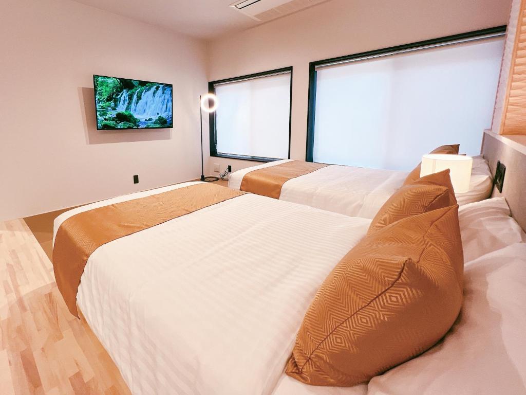 Postel nebo postele na pokoji v ubytování FELIZ ARIFUKU ONSEN