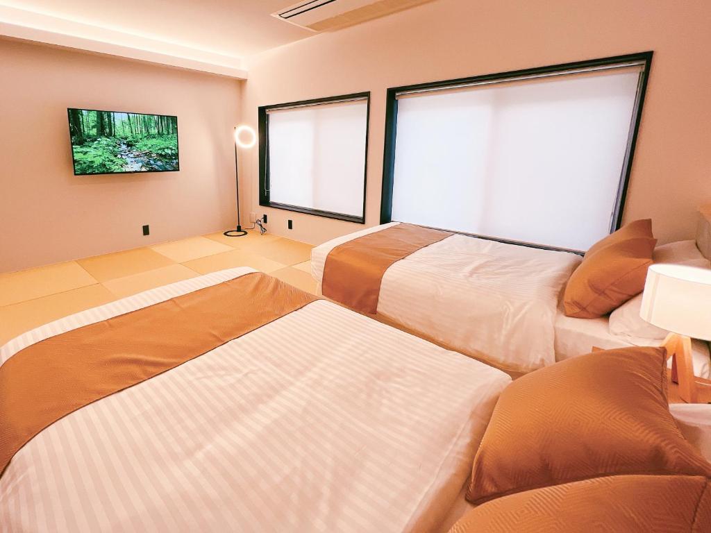 Postel nebo postele na pokoji v ubytování FELIZ ARIFUKU ONSEN