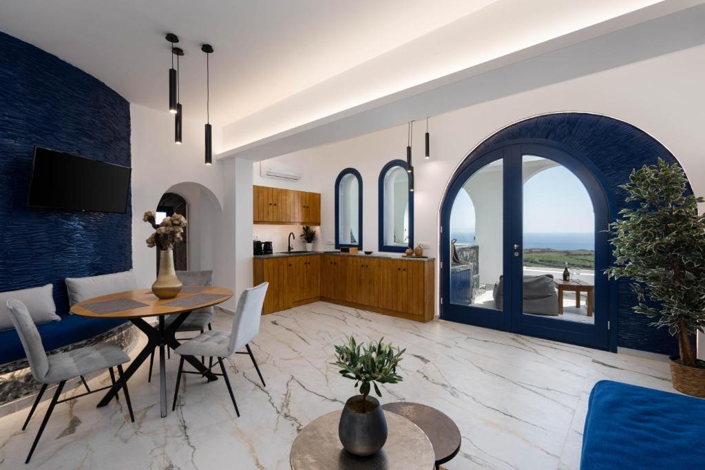 a kitchen and living room with a table and chairs at Amera Suites in Fira