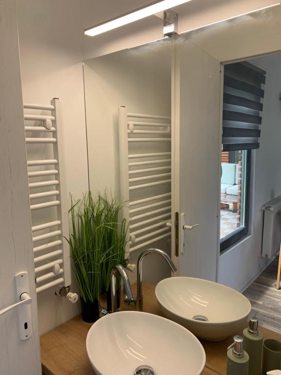 a bathroom with two sinks and a mirror at Tiny retreat in Miercurea-Ciuc