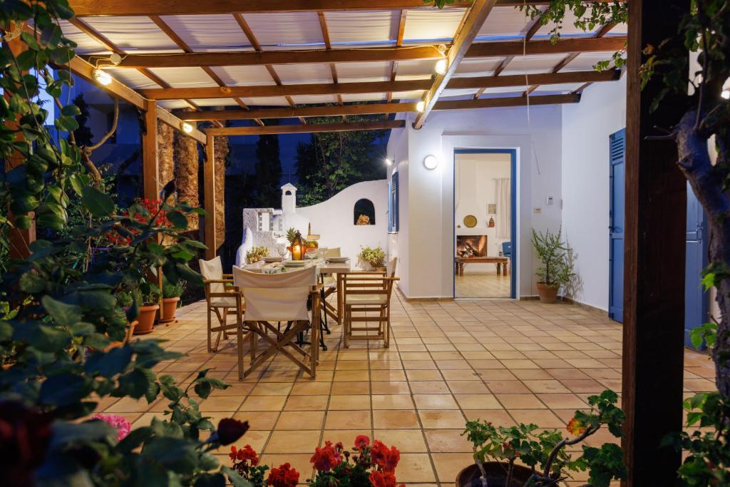 a patio with a table and chairs on it at Villa in the Garden in Kokkini Khanion