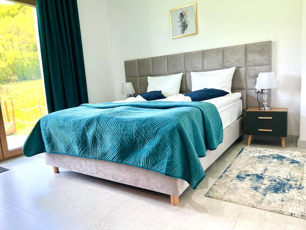 A bed or beds in a room at ELFF -Apartamenty i pokoje gościnne